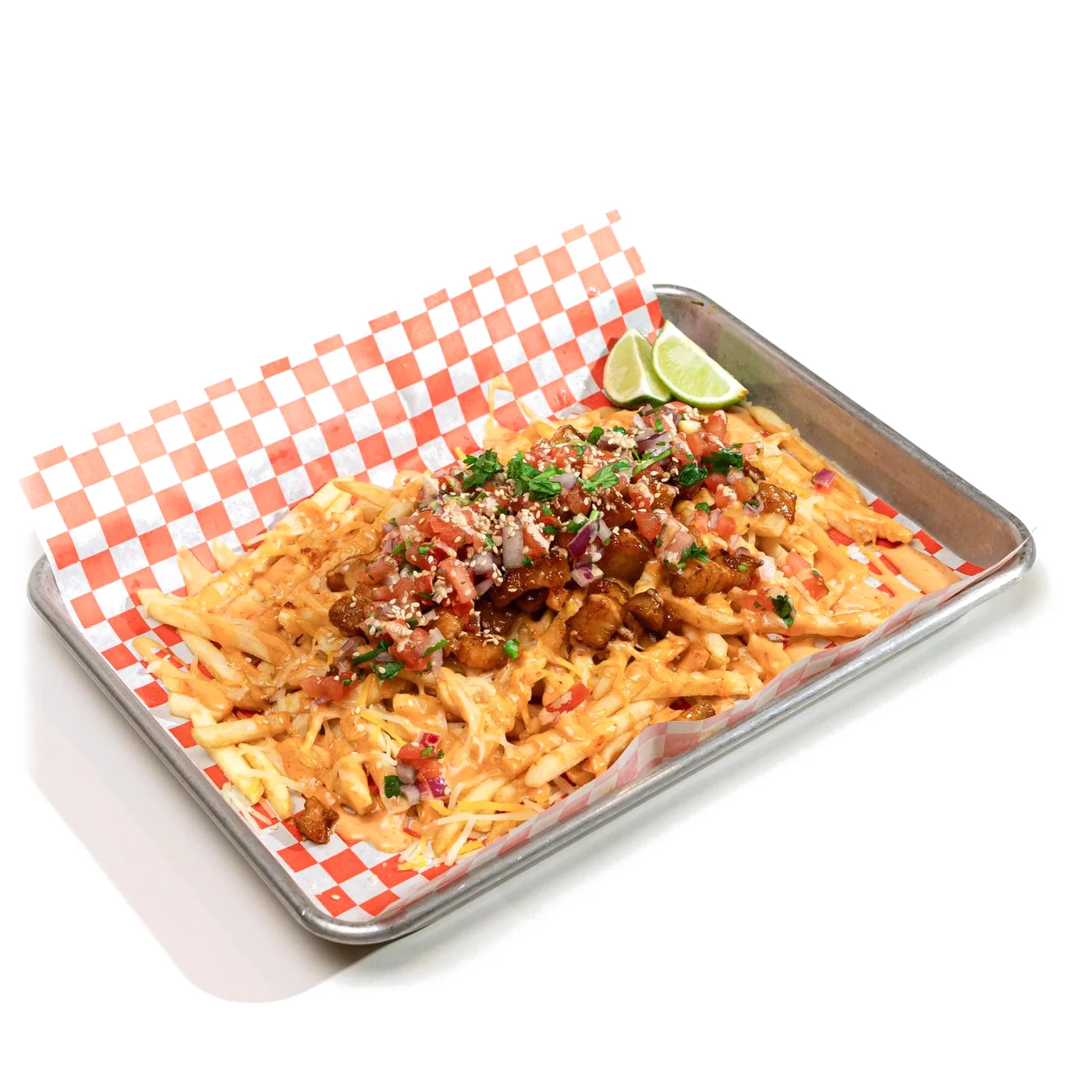 Pork Belly Fries on a steel tray lined with red-checked paper: fries under glazed pork belly, pico de gallo, cilantro, sesame seeds and sauce, with lime wedges